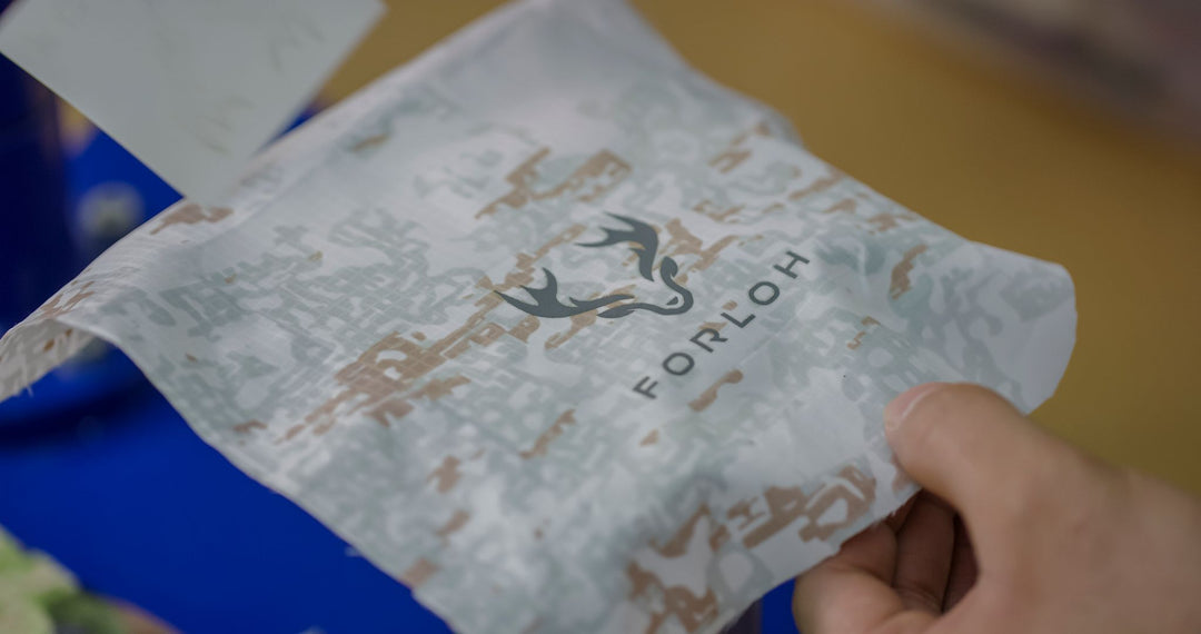 FORLOH Snowfall Camouflage article of clothing behind held in someone's hand