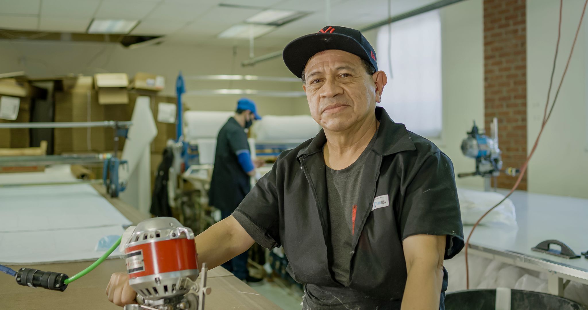 Man sitting in front of machine to start manufacturing American made products